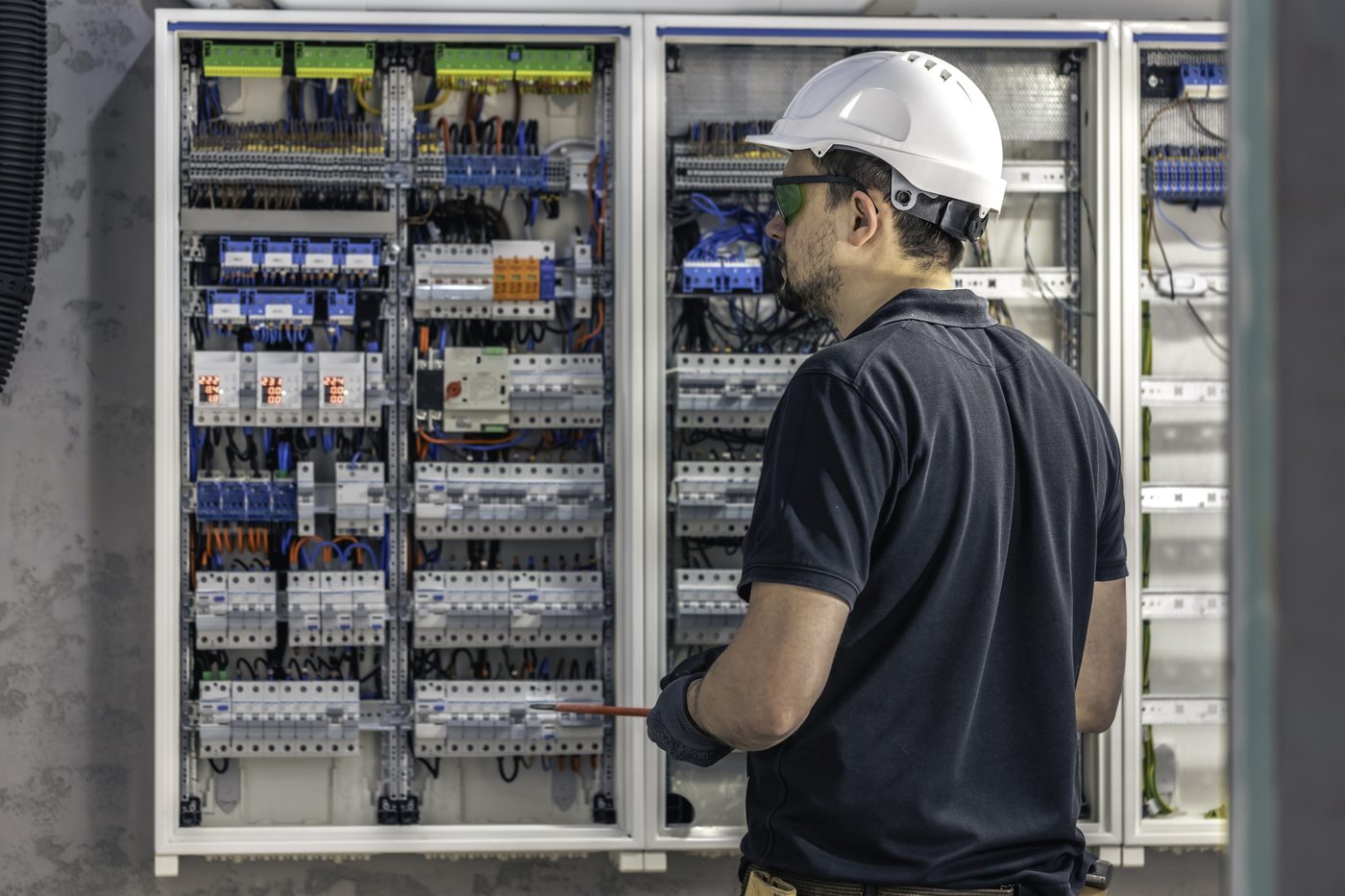Electrical engineer reviewing a control panel during consultancy